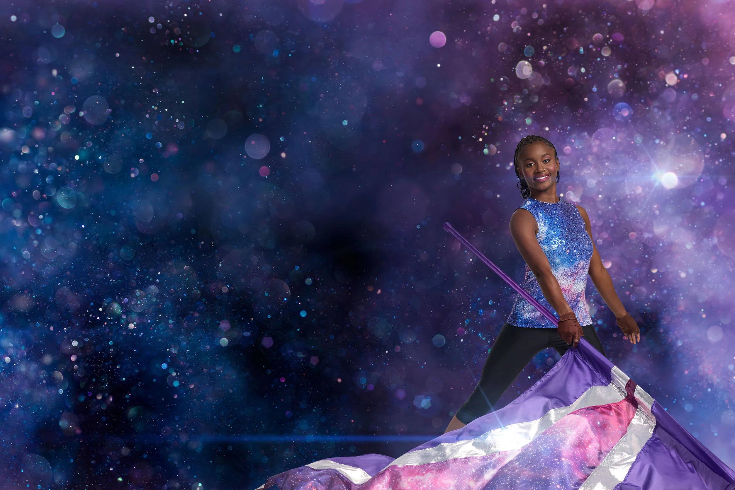 color guard girl holding a flag on a dark background